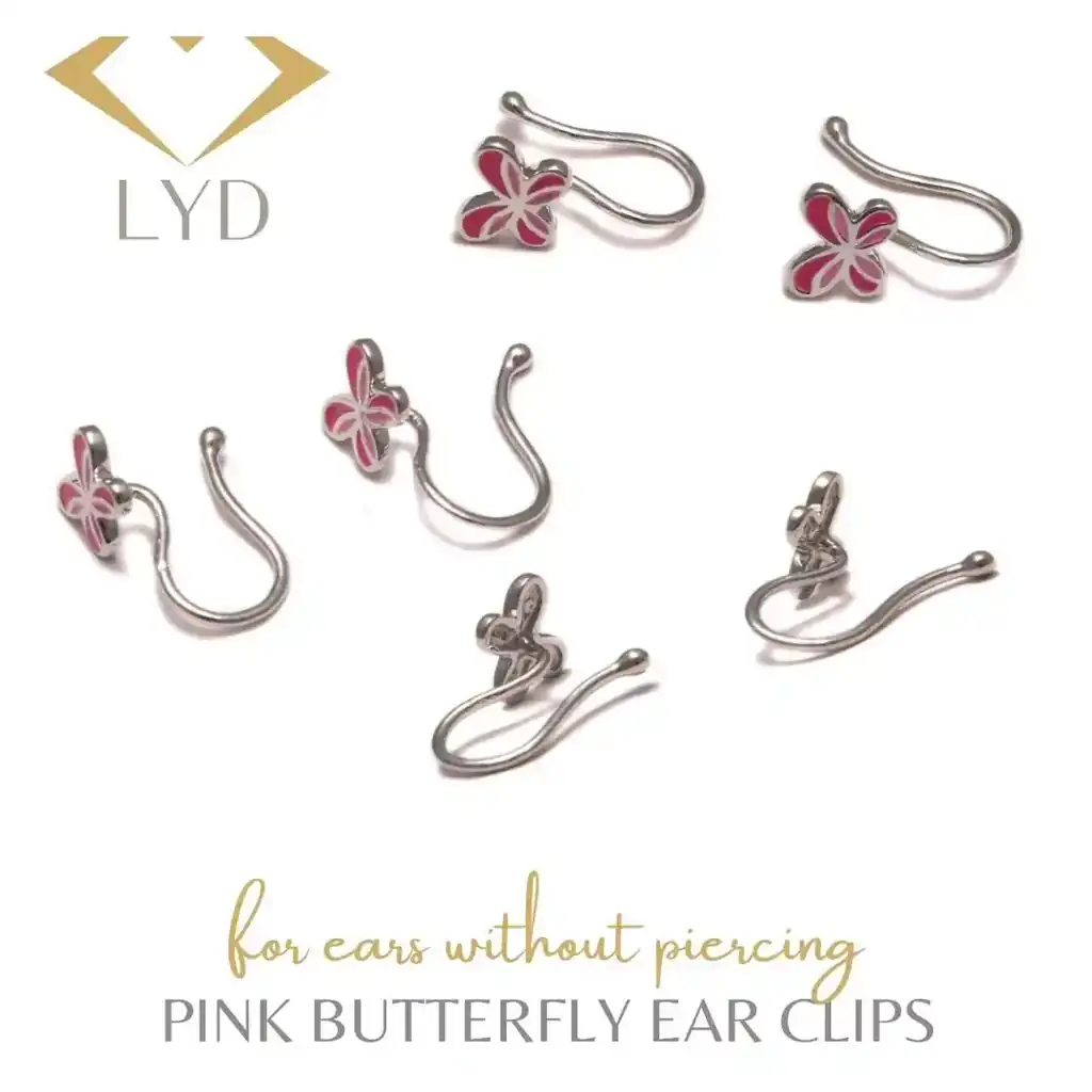 Product image of pink butterfly ear clips for ears without pierced ears. The clips are made of 925 sterling silver and are decorated with pink enamel. The design features delicate butterflies that create a playful look. The lettering emphasizes that these ear clips can be worn without pierced ears.